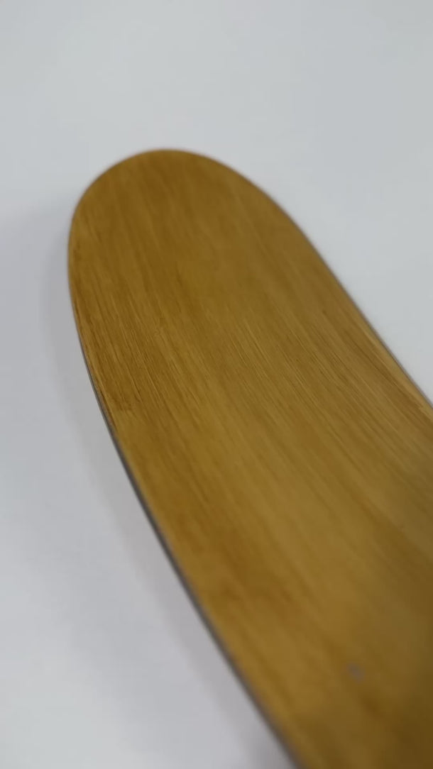 Close-up of the TOVI Vintage hockey stick shaft featuring a natural polished wood-grain finish, five red horizontal accent grip lines, and bold red and black TOVI branding with a high-gloss protective coat.